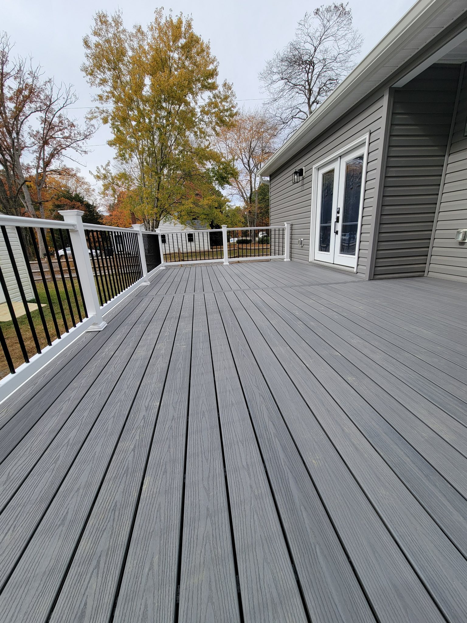 Backyard deck remodel enhancing outdoor living space with modern railings
